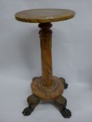 An early 19th Century Regency pedestal, the handpainted faux marble finish over ebonised quadruped