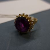 A fine quality 18k gold garnet ring flanked with seed pearls