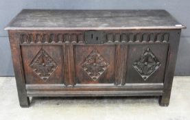 A late 18th Century oak coffer, having carved front panel raised on square supports, 65cm x 120cm