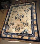 An antique Chinese Peking carpet, the all over ruby blossom design on an ivory ground with butterfly