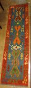 An anatolian kilim runner, the repeating geometric motifs on aqua ground within corresponding