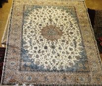 A large Isfahan design carpet, the central foliate medallion on an ivory ground with all over vine