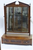 An early 19th Century Geogre III mahogany and satinwood banded toilet mirror, the rectangular