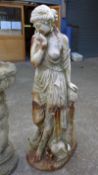 A large white painted cast iron garden statue of a classical maiden dressed in a flowing gown on