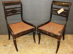 A pair of early 19th Century Regency ebonised and gilt decorated side chairs, the caned seats over