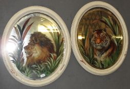 A pair of early 20th Century white painted oval wall mirrors, the antique bevelled plates having