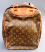 A designer Louis Vuitton leather shoe bag having all over typical design along with a Louis