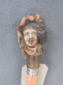 A fine Malacca walking stick with carved boxwood cavaliers head and feathered cap, the face with