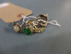 A collection of four 18k gold Indian rings, mounted with various precious stones and a collection of