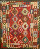A contemporary Afghan kilim rug, the central geometric design on a scarlet ground within multiple