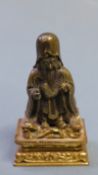 A 19th Century bronze figure of a sage on original wooden stand, signed to base, H. 11.5cm