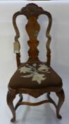An 18th Century Dutch inlaid walnut side chair, the vase shaped splat with figural inlaid detail