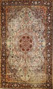 An antique Indian pure silk kashmir rug, the central foliate medallion on an ivory ground within
