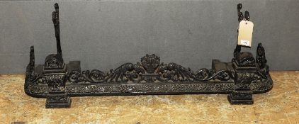 A late 19th Century Victorian black painted cast iron fender, having pierced scrolling decoration