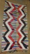 A vintage Boucherouite kilim, the all over vibrant geometric design on a flat weave ground 250cm x