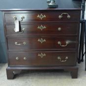 A late 18th Century George III mahogany chest of four long graduated drawers raised on bracket