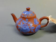A Chinese Yixing teapot with enamel floral decoration