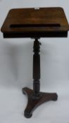 An early 19th Century Regency rosewood reading table, the adjustable lecturn over reeded central