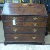 A late 18th Century George III oak bureau, the fall front enclosing fitted interior over two short