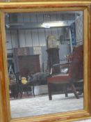 A 19th Century giltwood wall mirror, the rectangular antique plate within gilt and red moulded frame