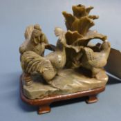 A Chinese 20th Century carved soapstone figure of hens in naturalistic setting on wooden stand