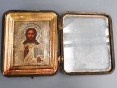 A late 19th Century Oklad icon, silver mounted Christ pantocrator, original mahogany case, 24cm x