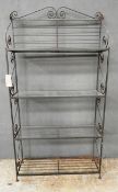 A contemporary French baker's rack design open display case, the scrolled metalwork frame having