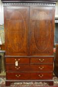 An early 19th Century George III mahogany linen press, the moulded cornice over twin cupboard