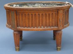 A 19th Century mahogany oval wine cooler raised on fluted supports 54cm x 36cm