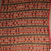 An antique Turkoman Chador rug, the all over geometric banded design on a flat weave terracotta