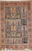 A Persian Qum rug, the all over tree of life design within peach border with repeating floral motifs