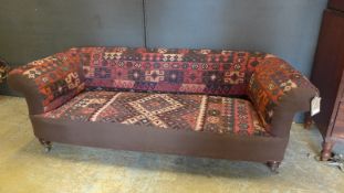 A mid 19th Century Victorian Chesterfield sofa, the vibrant Maimana Afghan kilim upholstery over