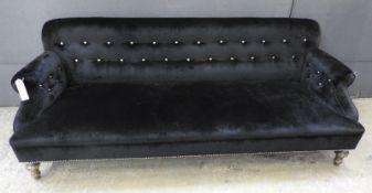 A 19th Century Georgian sofa, the studded black velvet upholstery over turned giltwood supports, W