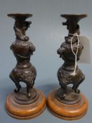 A pair of Japanese Meiji period urns on stands, profusely decorated with dragons H.24cm