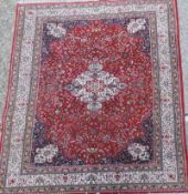 A Persian kashan rug, the ivory central foliate medallion on a rouge ground with vine decoration