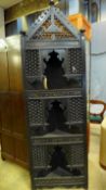 An early 20th Century Moorish carved and ebonised floor standing corner cabinet with calligraphy