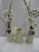 *CREAM ENAMEL JUG AND 2 FLOWERS ARRANGEMENTS