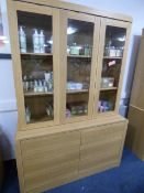 *WALL UNIT ENCLOSED BY 3 GLAZED DOORS OVER DRAWERS IN WHITE OAK FINISH