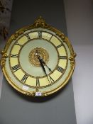 Ornate Wall Clock with Roman Numeral Face and Gilt Trim