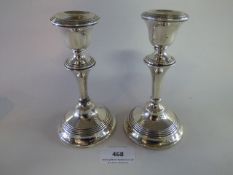 A Pair of Silver Candle Sticks at Fault