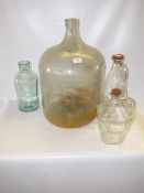 glass carboy and three large glass containers