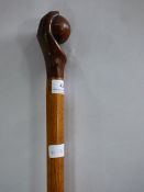 walking stick carved as a hand and ball