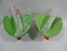 Pair of green lobster salad bowls with servers