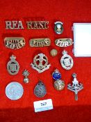 a collection of military cap badges etc