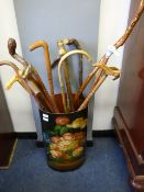 collection of walking sticks in umbrella stand