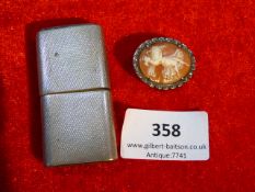 silver cased cigarette lighter and a cameo