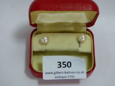 pair of pearl earrings with white gold metal scrolls