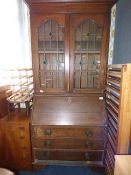 Oak bureau book case with leaded glass doors