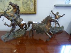 Pair of bronze male figures with stallions