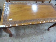 Carved teak occasional table on ball and claw feet